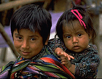 Boy carrying sister to market.