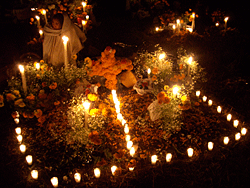 woman at candle lite grave